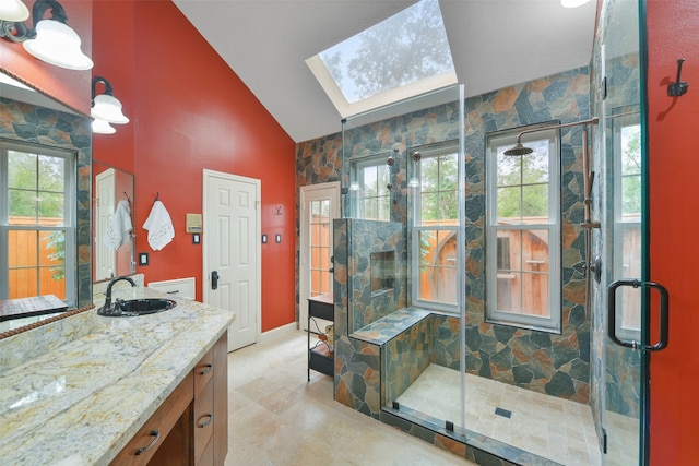 bathroom featuring a shower with door, plenty of natural light, and vanity