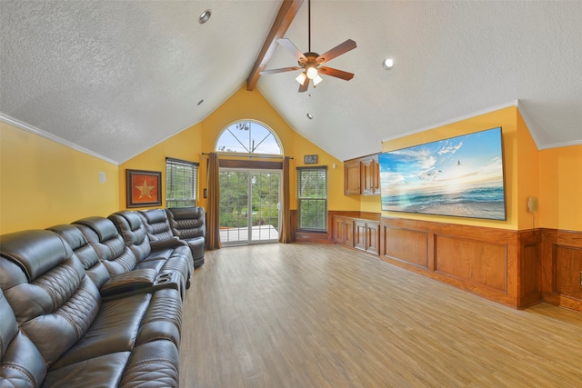 living room with a textured ceiling, crown molding, ceiling fan, and light wood-type flooring