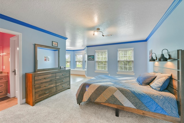 carpeted bedroom featuring ornamental molding, a textured ceiling, and ensuite bathroom