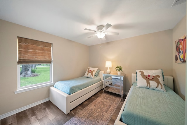 bedroom with dark wood-type flooring and ceiling fan