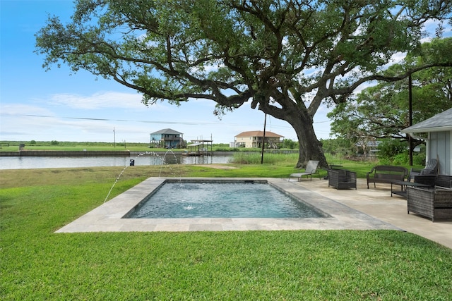 view of swimming pool with a water view, a patio area, a lawn, and pool water feature