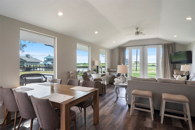 dining area with ceiling fan, dark hardwood / wood-style flooring, and vaulted ceiling