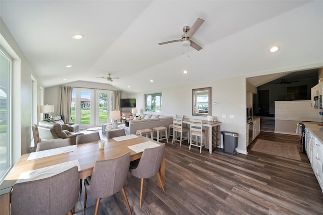 dining space with vaulted ceiling, dark hardwood / wood-style flooring, and ceiling fan