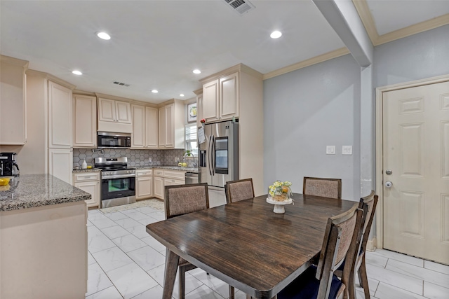 dining space with ornamental molding and sink