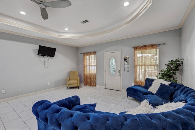 living room with crown molding, a raised ceiling, and ceiling fan