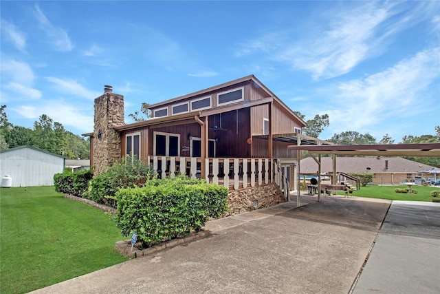 view of front of house featuring a front yard and a chimney