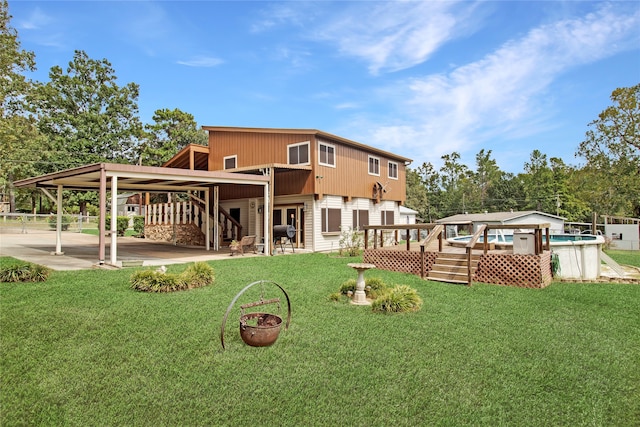 back of property with a patio area and a lawn