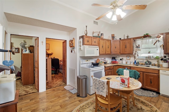 kitchen with white appliances, crown molding, sink, ceiling fan, and light wood-type flooring