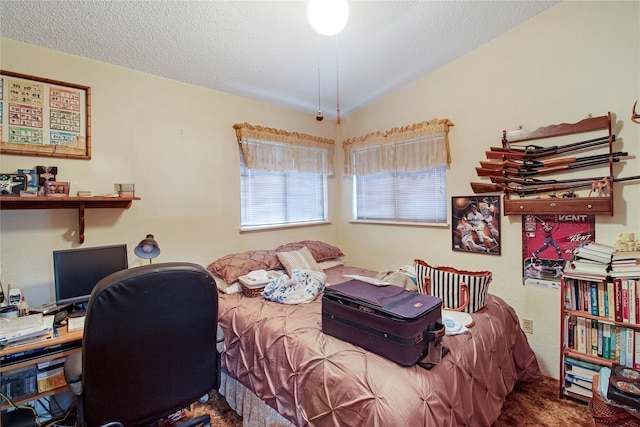 bedroom with a textured ceiling and vaulted ceiling