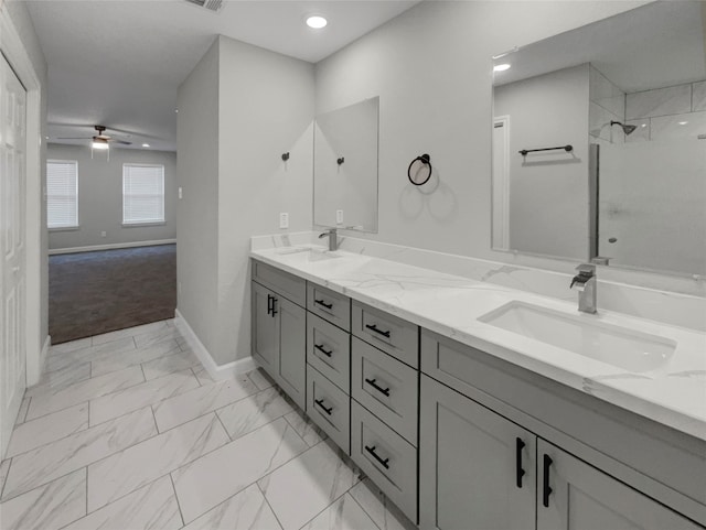 bathroom with ceiling fan, a tile shower, and vanity