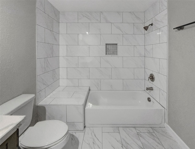 full bathroom with vanity, toilet, and tiled shower / bath combo