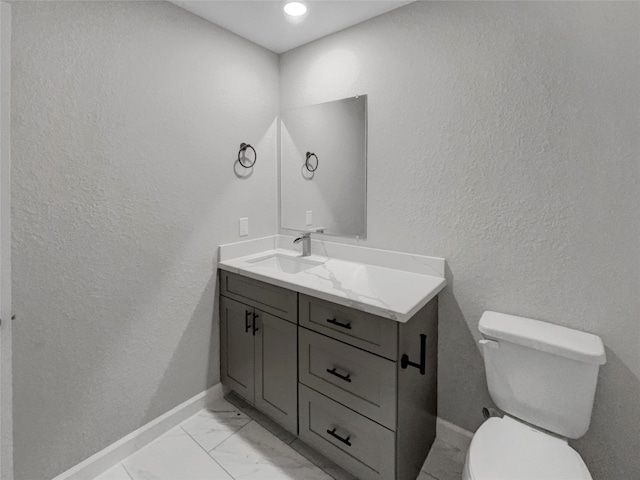 bathroom with toilet and vanity