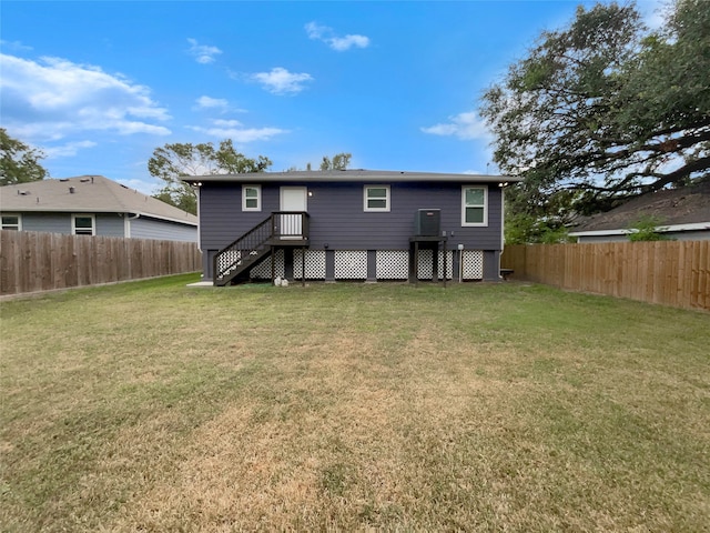 back of house with a lawn