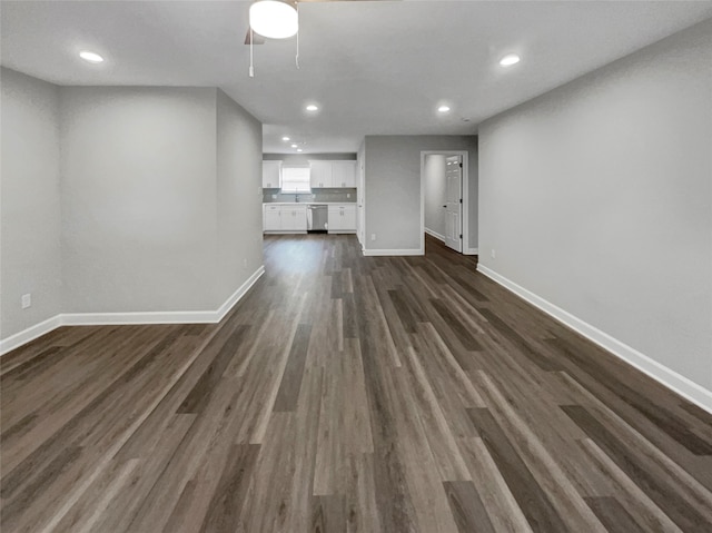 unfurnished living room with ceiling fan and dark hardwood / wood-style flooring