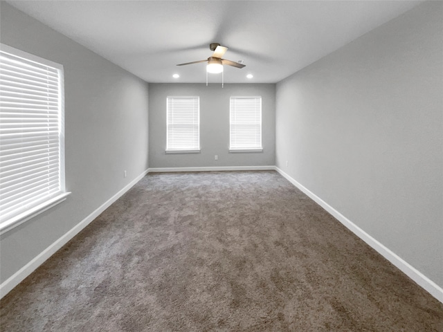 empty room featuring ceiling fan and carpet floors