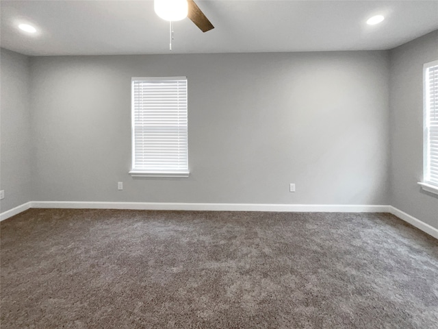 unfurnished room with ceiling fan, plenty of natural light, and carpet floors