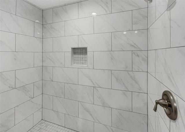 bathroom with a tile shower