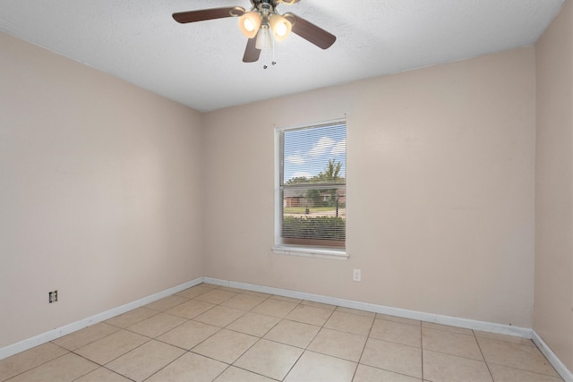 empty room with light tile patterned floors, a textured ceiling, and ceiling fan