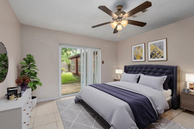 tiled bedroom featuring ceiling fan, a textured ceiling, and access to outside