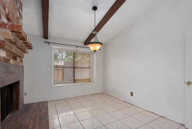 unfurnished living room with a fireplace, beam ceiling, a textured ceiling, and light tile patterned floors