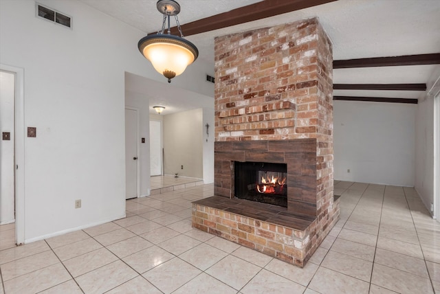 unfurnished living room with a textured ceiling, lofted ceiling with beams, light tile patterned floors, and a fireplace