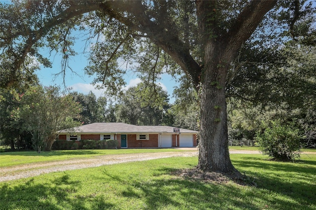 ranch-style home featuring a front yard and a garage