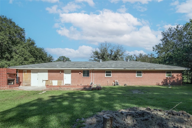 back of property featuring a patio area and a yard