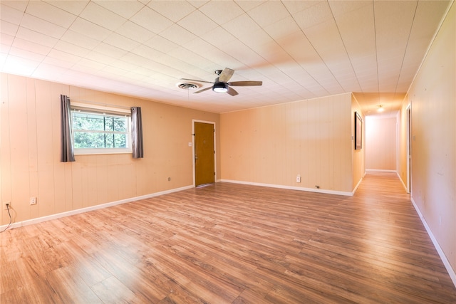 empty room with wood-type flooring and ceiling fan