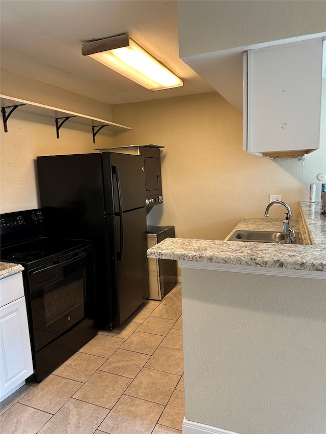 kitchen featuring black appliances, sink, light tile patterned floors, white cabinetry, and kitchen peninsula