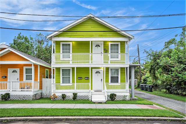 view of front of property featuring a balcony and covered porch