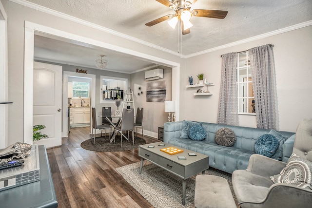 living room featuring a textured ceiling, crown molding, an AC wall unit, hardwood / wood-style flooring, and ceiling fan