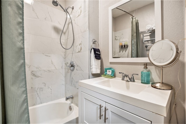 bathroom featuring vanity and shower / bathtub combination with curtain