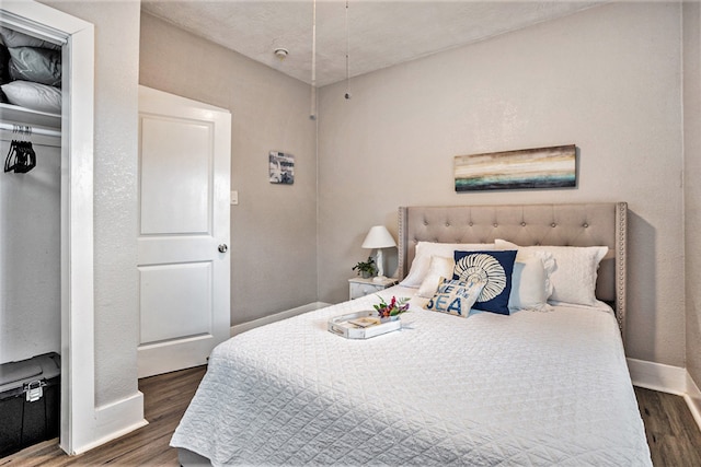 bedroom with dark wood-type flooring