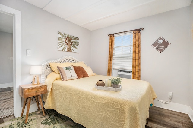 bedroom featuring cooling unit and dark hardwood / wood-style flooring