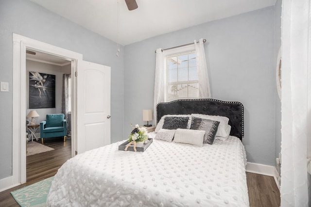 bedroom featuring dark wood-type flooring and ceiling fan