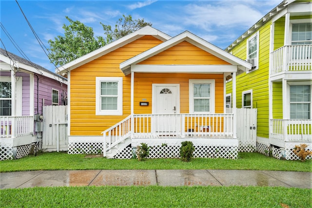 view of front facade with a front yard and a porch