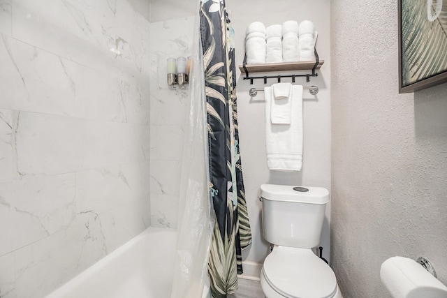 bathroom featuring shower / bath combo with shower curtain and toilet