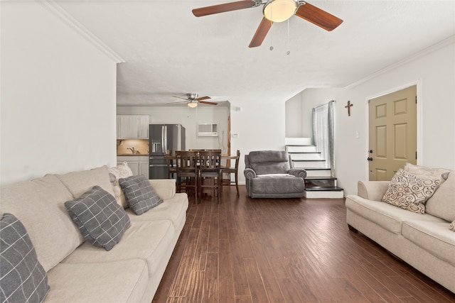 living room with ornamental molding, dark wood-type flooring, and ceiling fan