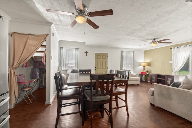 dining space with ceiling fan, ornamental molding, dark hardwood / wood-style flooring, and a textured ceiling