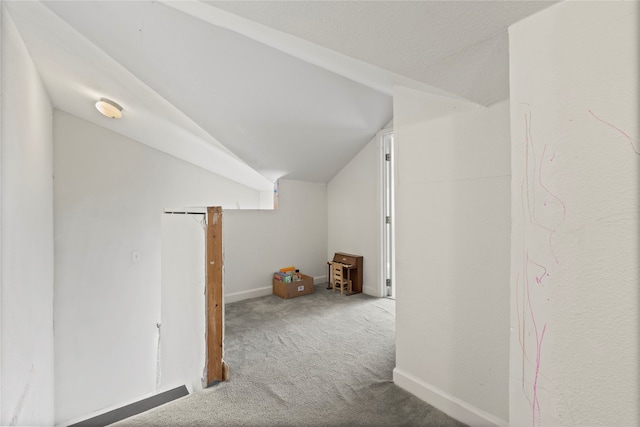 bonus room featuring vaulted ceiling and carpet floors