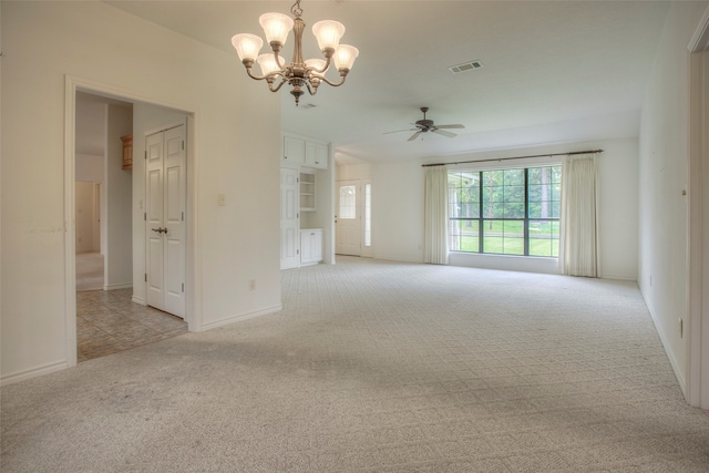 interior space featuring ceiling fan with notable chandelier and light carpet