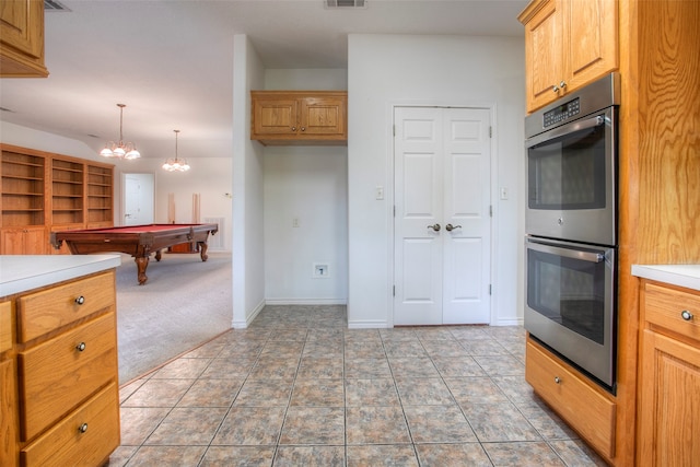 kitchen featuring double oven, pool table, light colored carpet, and pendant lighting