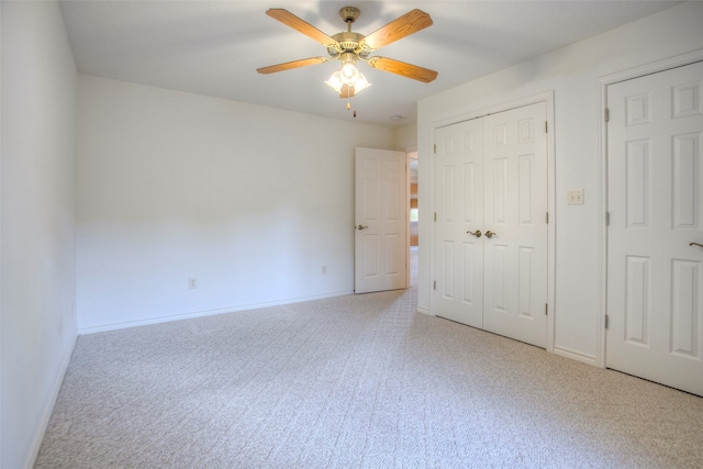 unfurnished bedroom featuring ceiling fan and light colored carpet