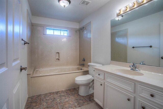 full bathroom with tile patterned floors, toilet, tiled shower / bath combo, and vanity