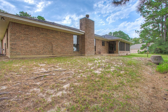 back of property with a sunroom