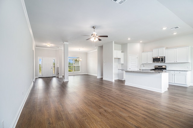 unfurnished living room featuring crown molding, sink, ceiling fan with notable chandelier, and dark wood-type flooring