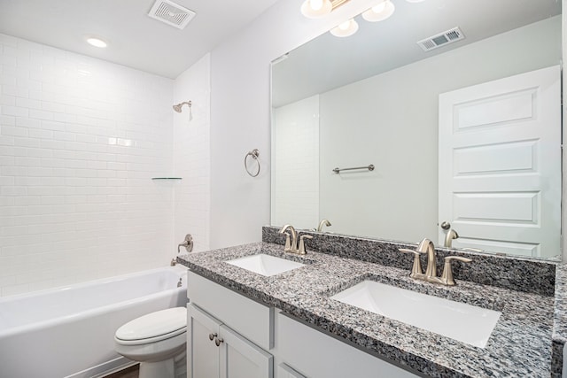 full bathroom featuring vanity, toilet, and tiled shower / bath combo