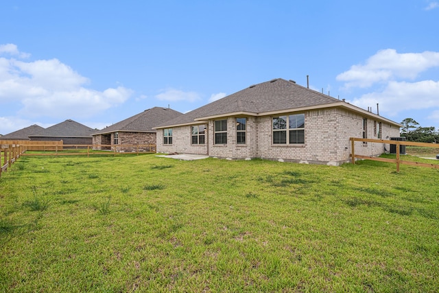 back of property with a patio area and a lawn