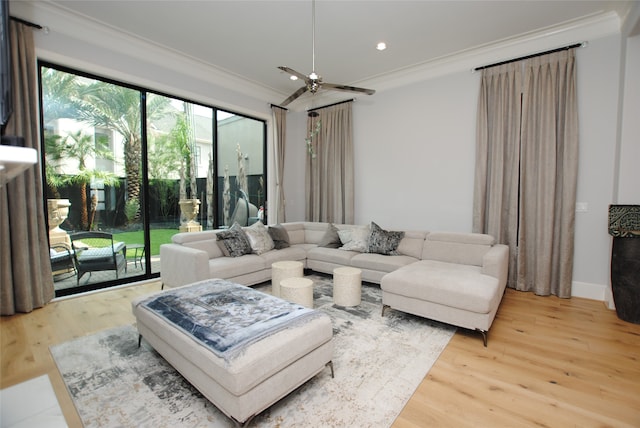 living room with light wood-type flooring, ceiling fan, and a healthy amount of sunlight