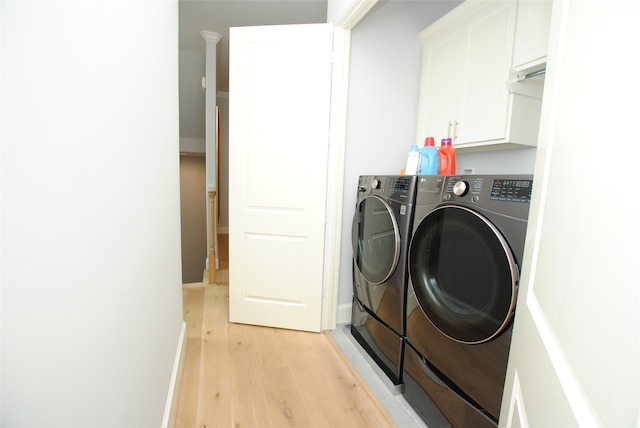 laundry area with light wood-type flooring, cabinets, and independent washer and dryer